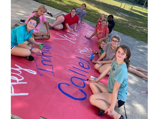 students painting banner